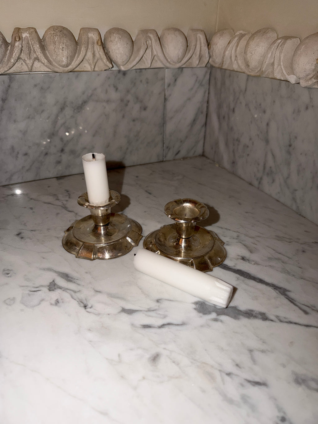 A pair of candlesticks in new silver