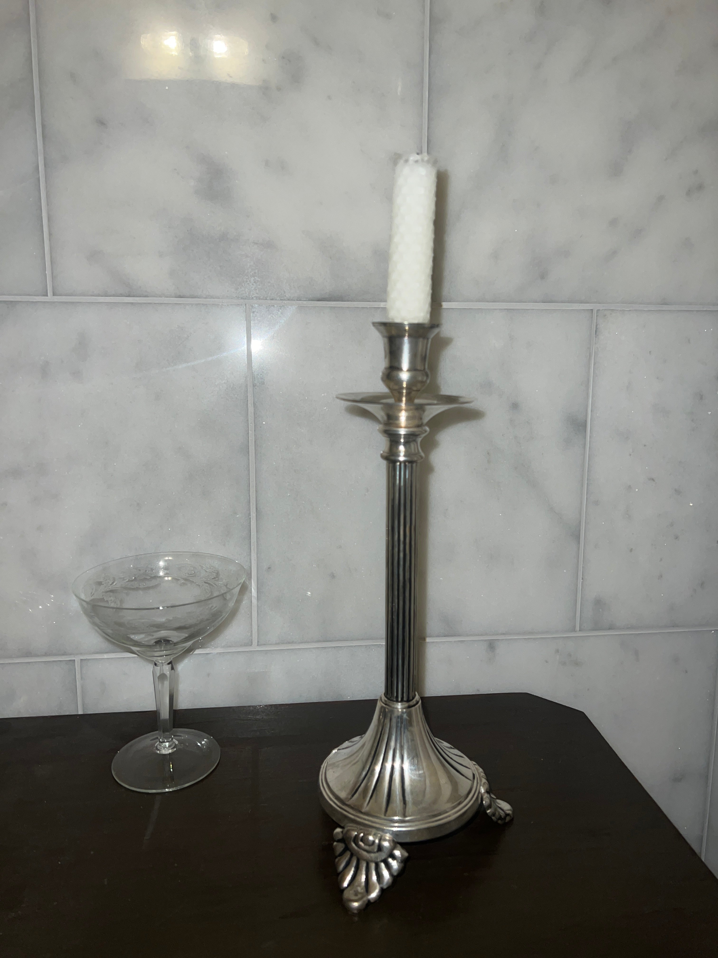 A tall vintage candle stick