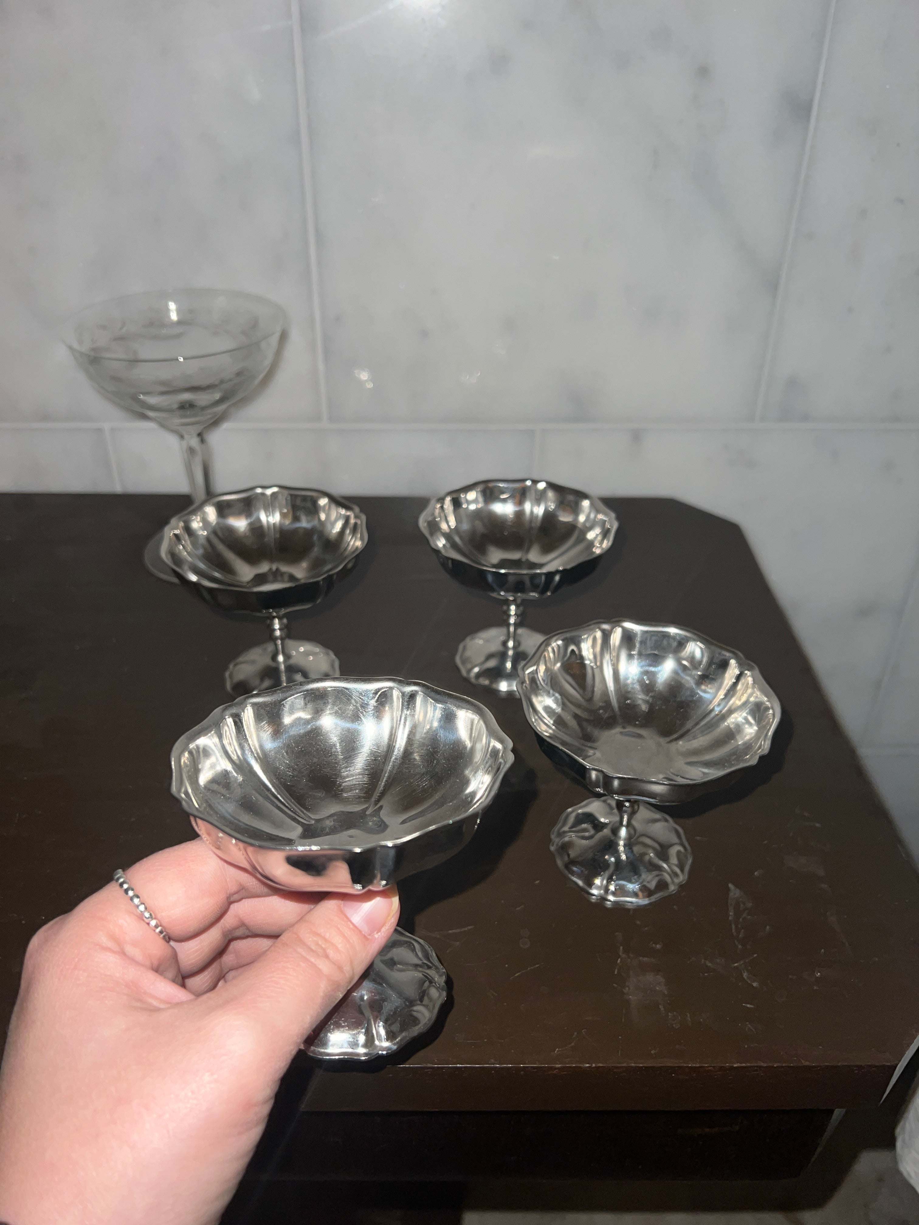 A set of four vintage stainless steel dishes