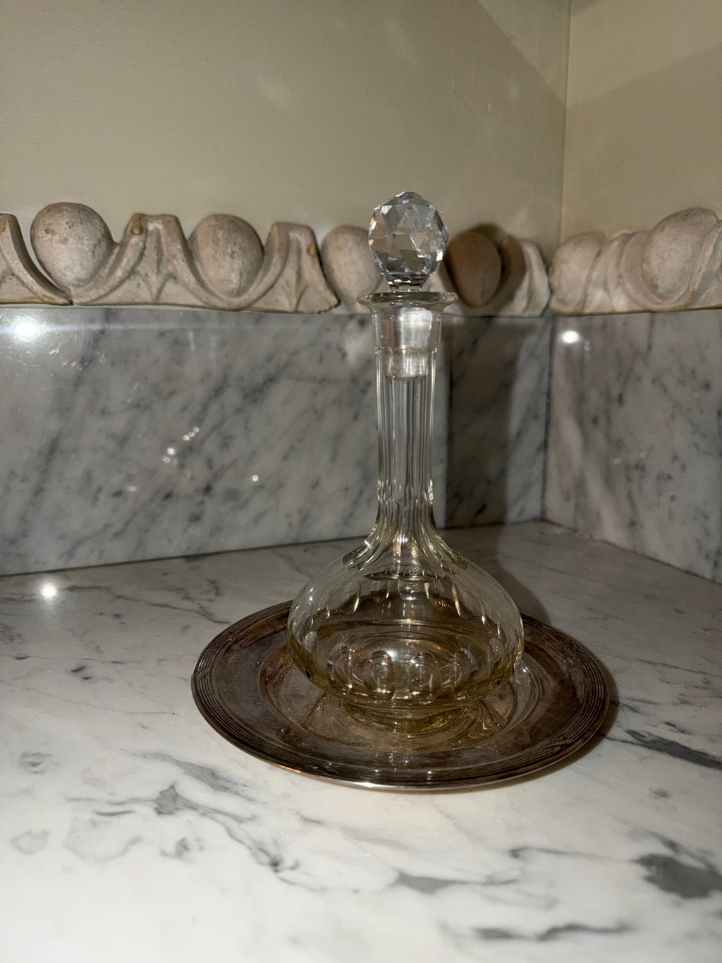 Small crystal bottle with a new silver tray