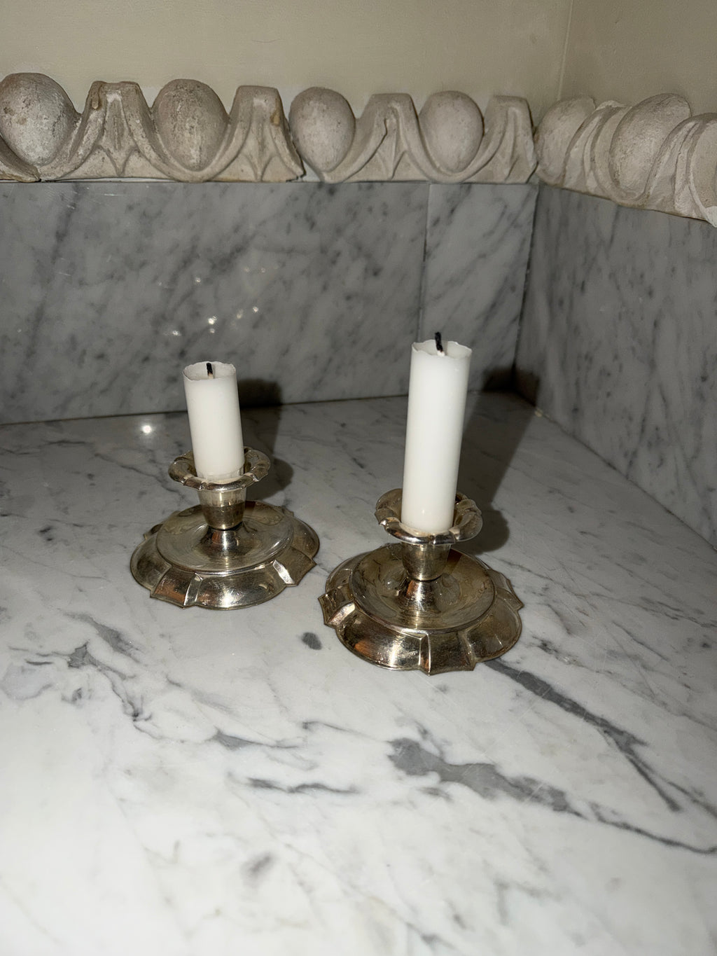 A pair of candlesticks in new silver