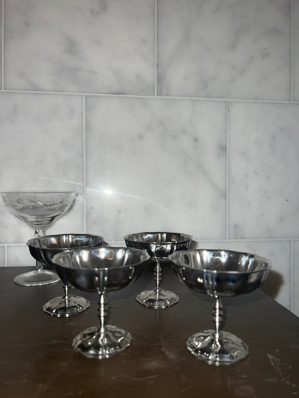 A set of four vintage stainless steel dishes