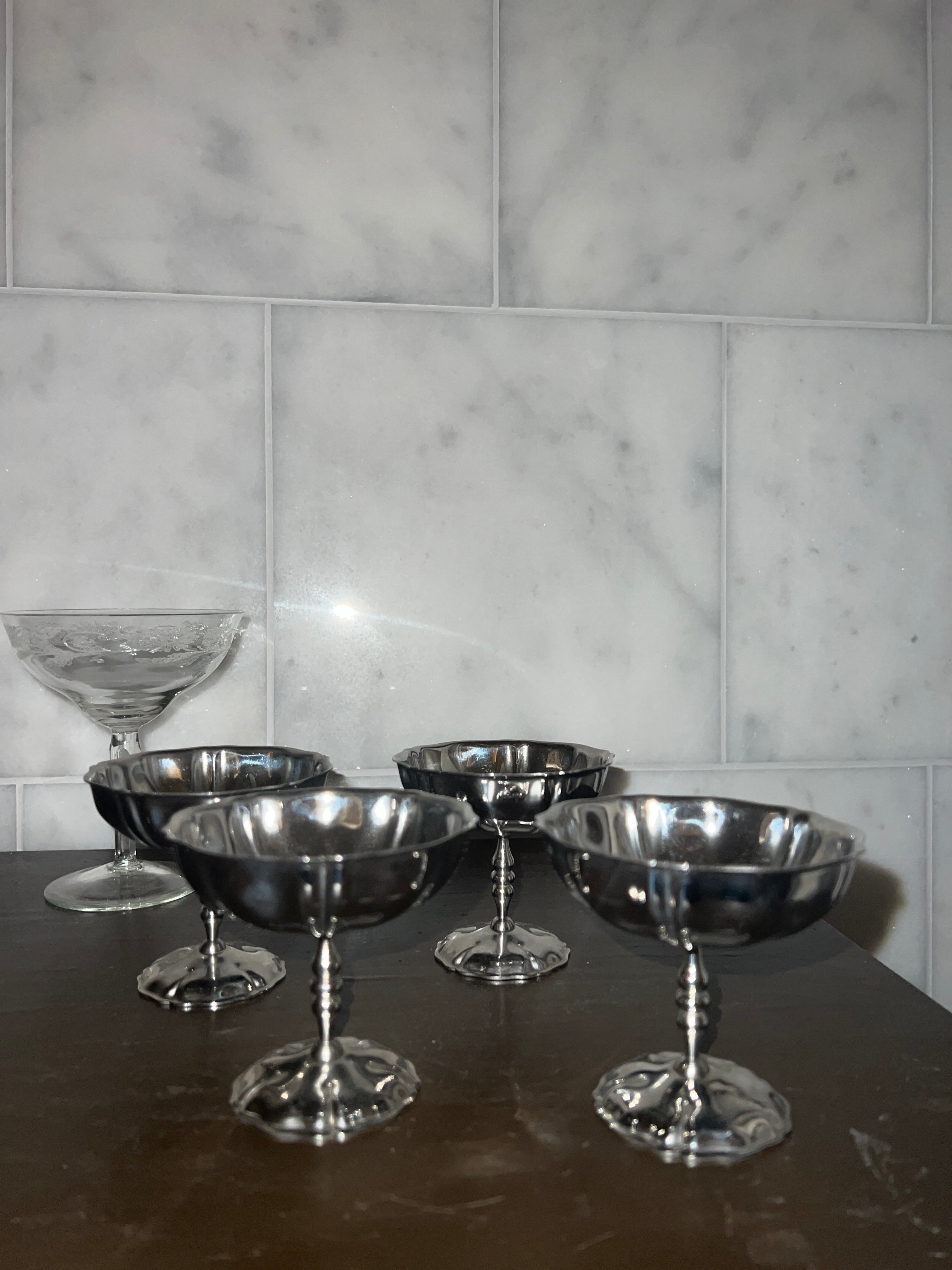 A set of four vintage stainless steel dishes