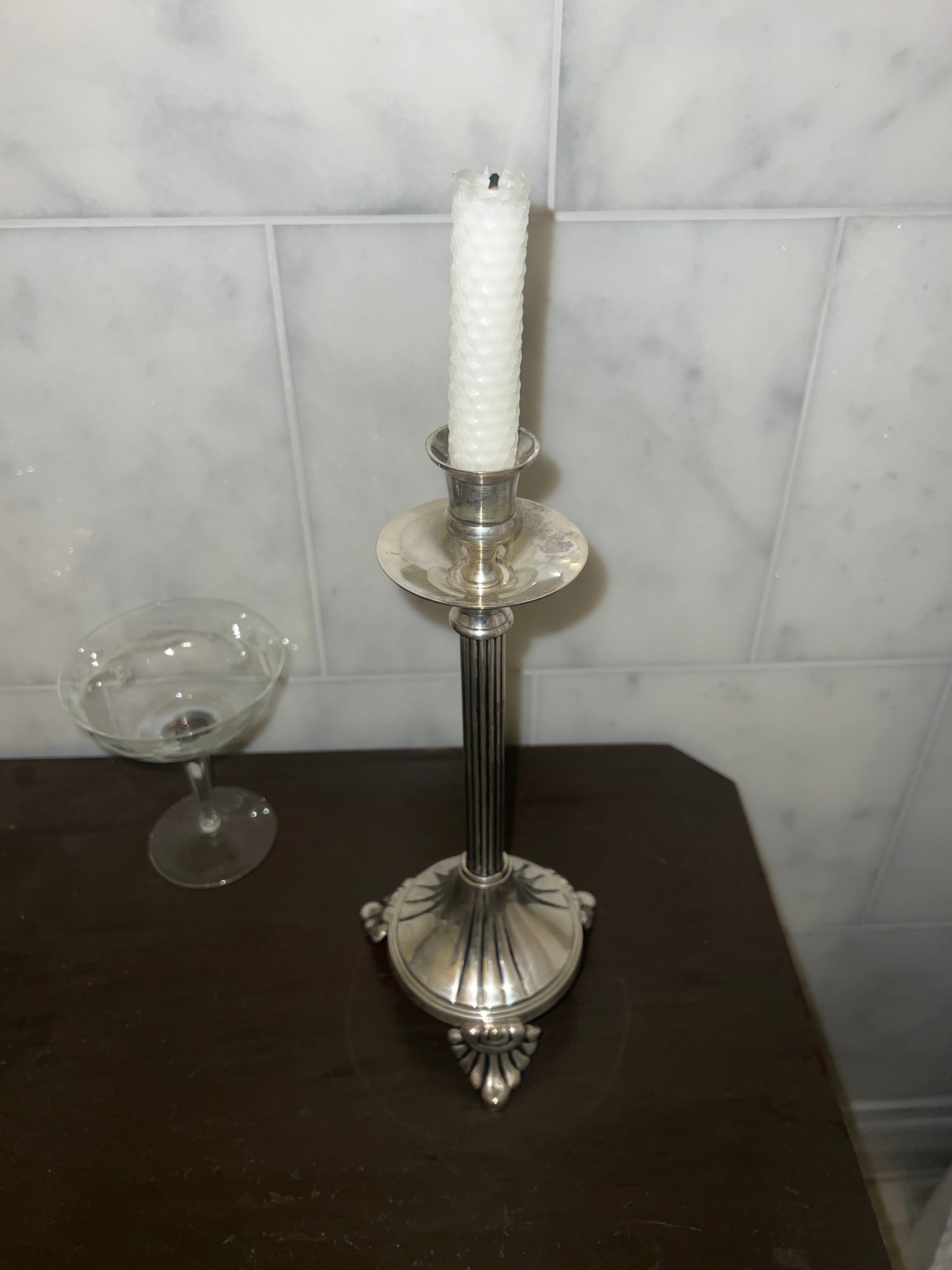 A tall vintage candle stick