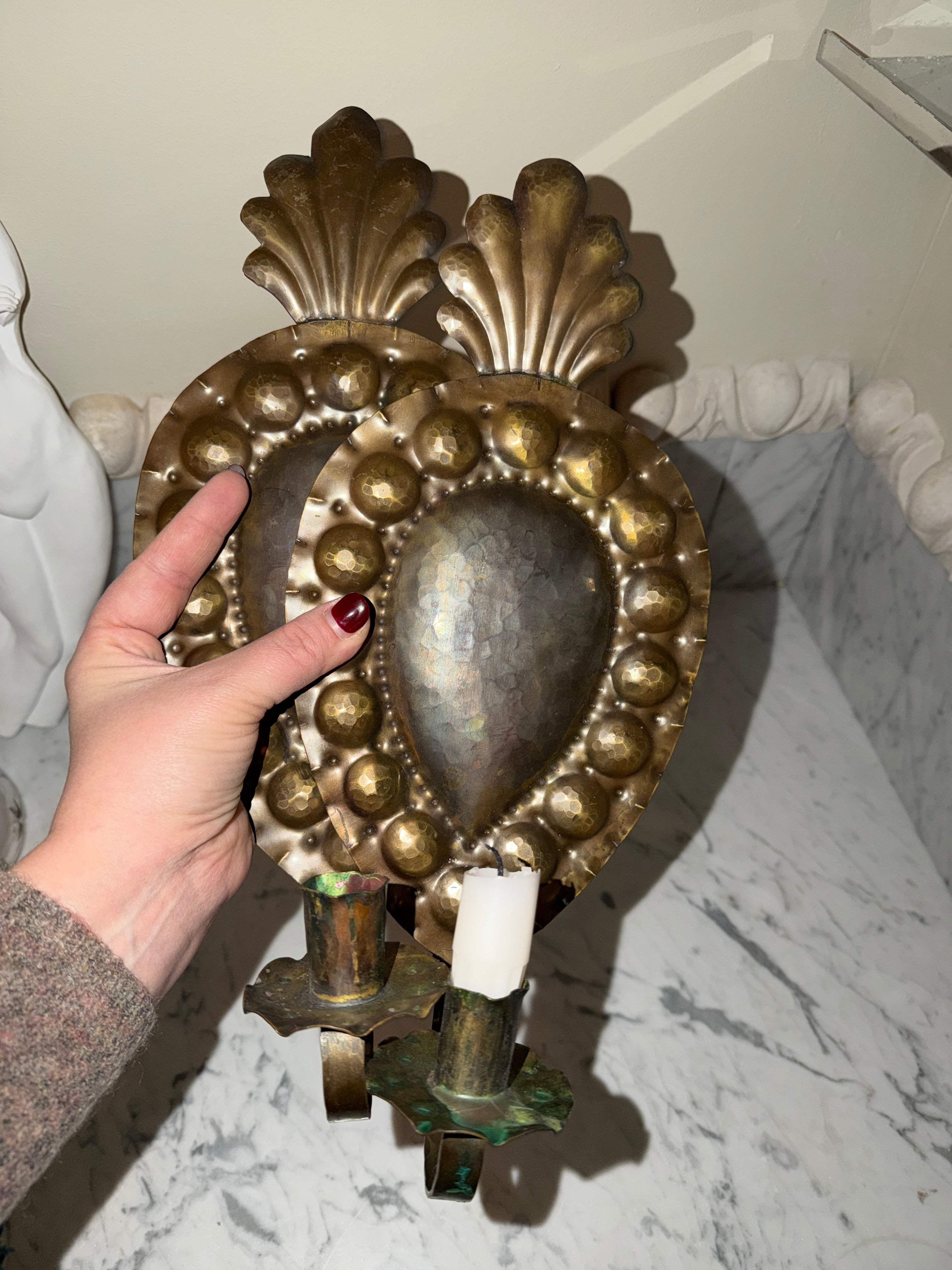 A pair of antique candle sconces