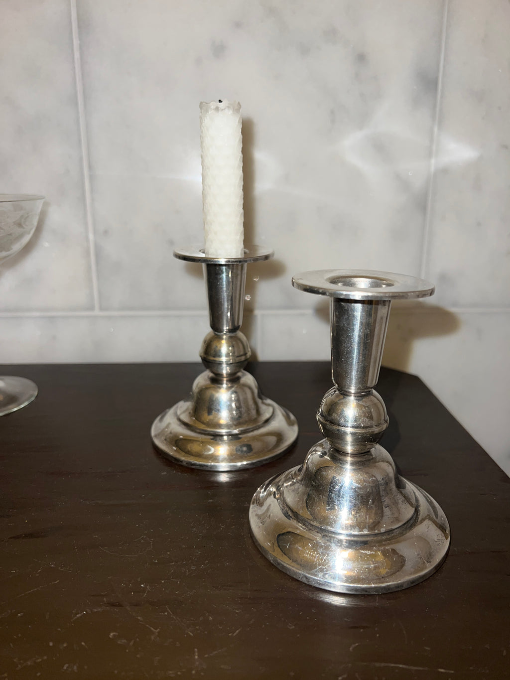 A pair of candle sticks in new silver