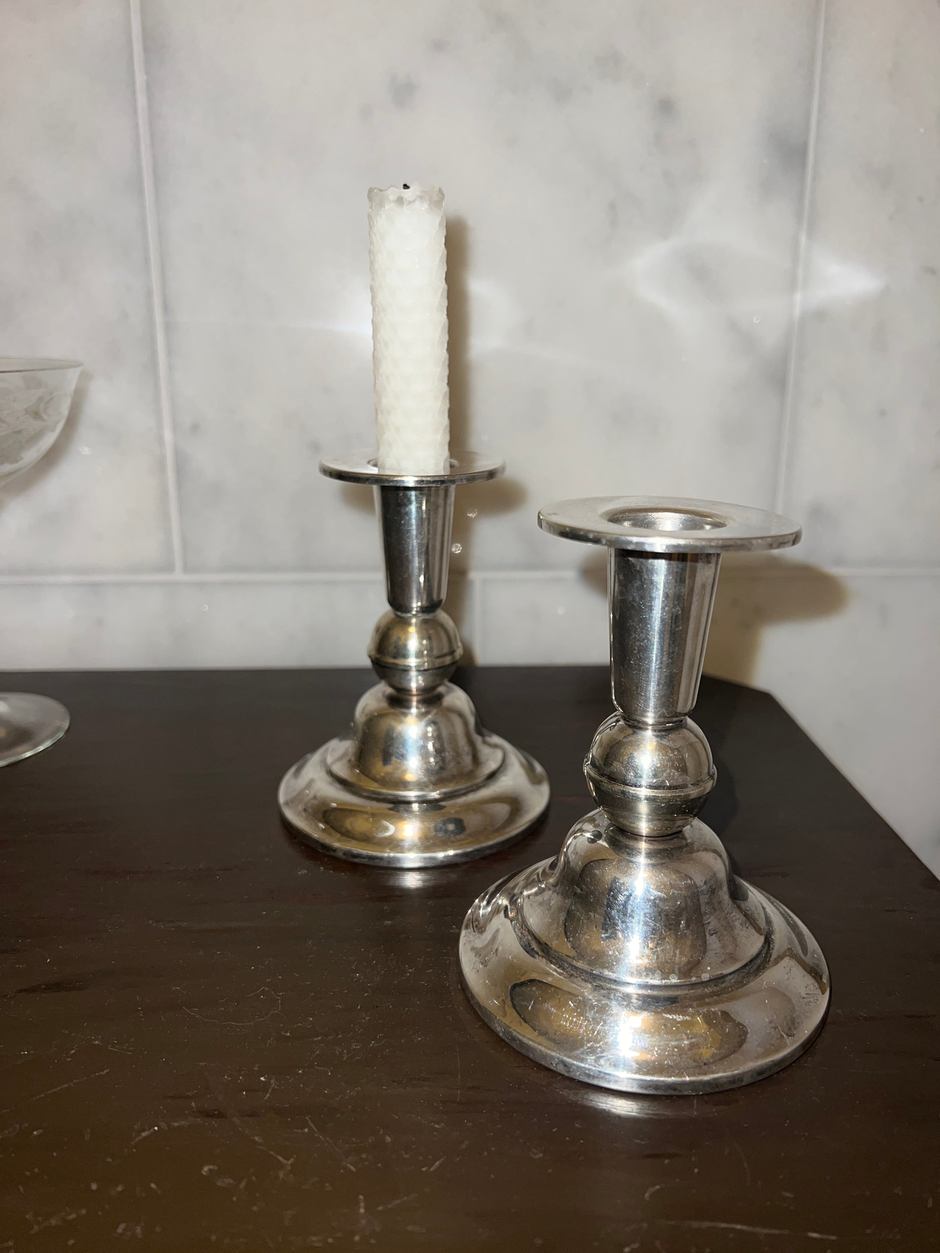 A pair of candle sticks in new silver