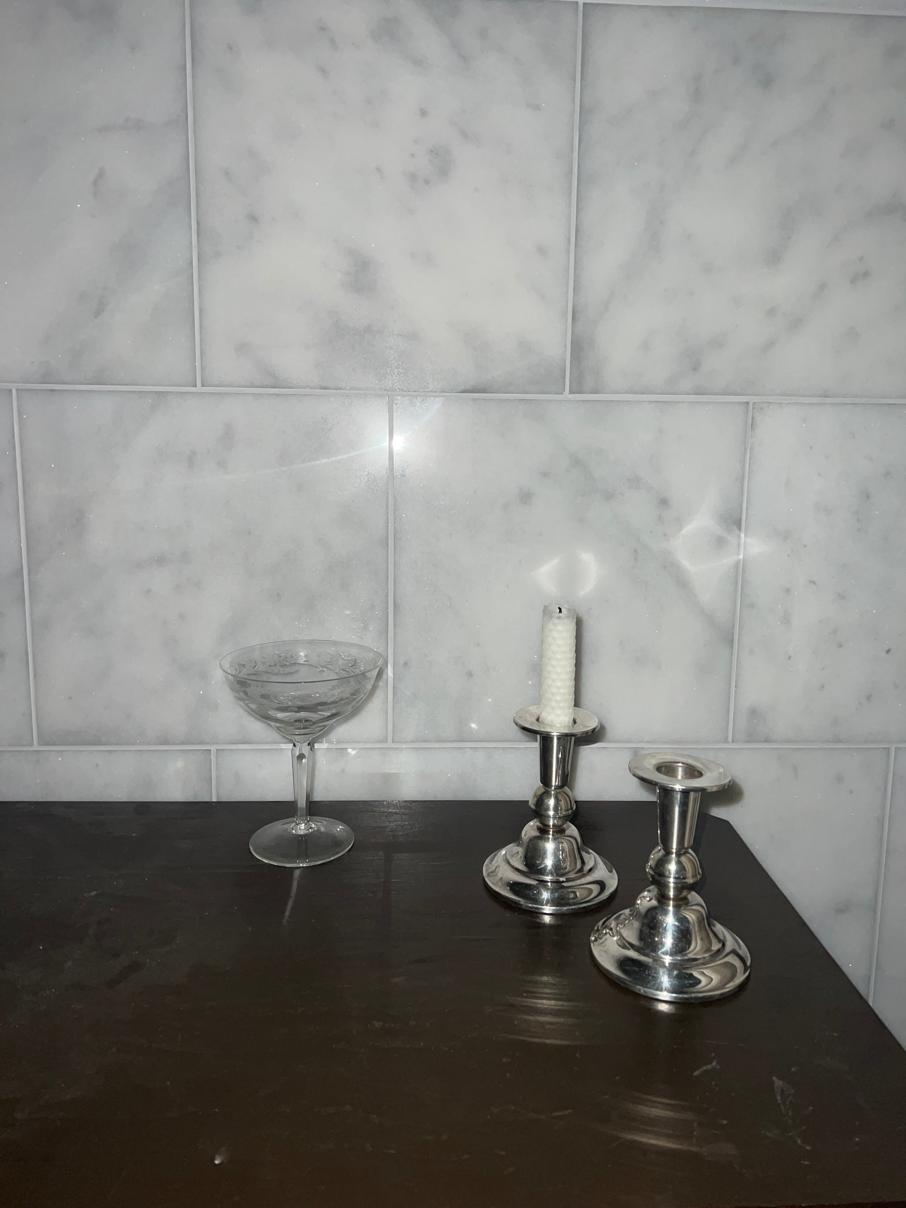 A pair of candle sticks in new silver